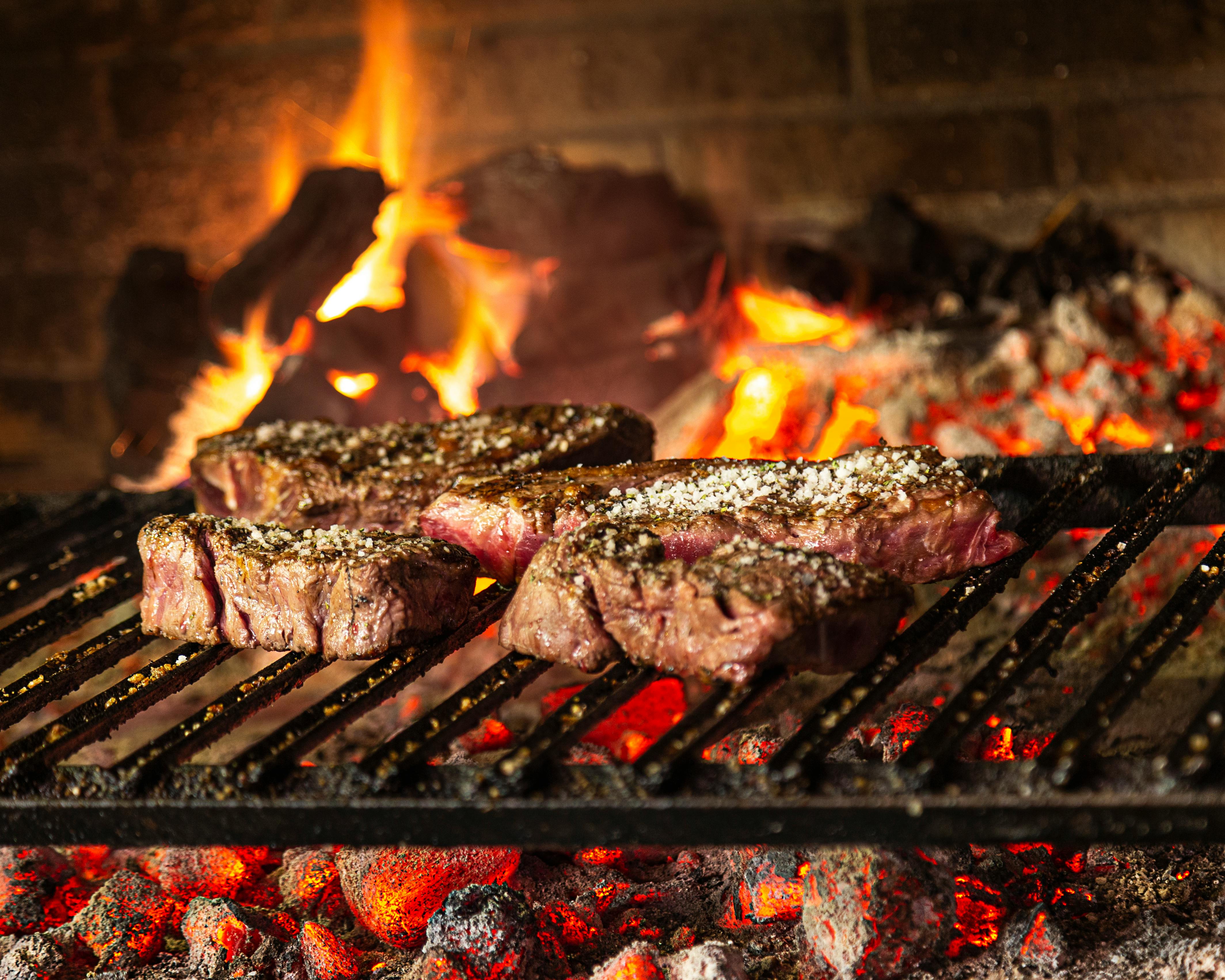 Char-grilled meats over open flame — Fire Que